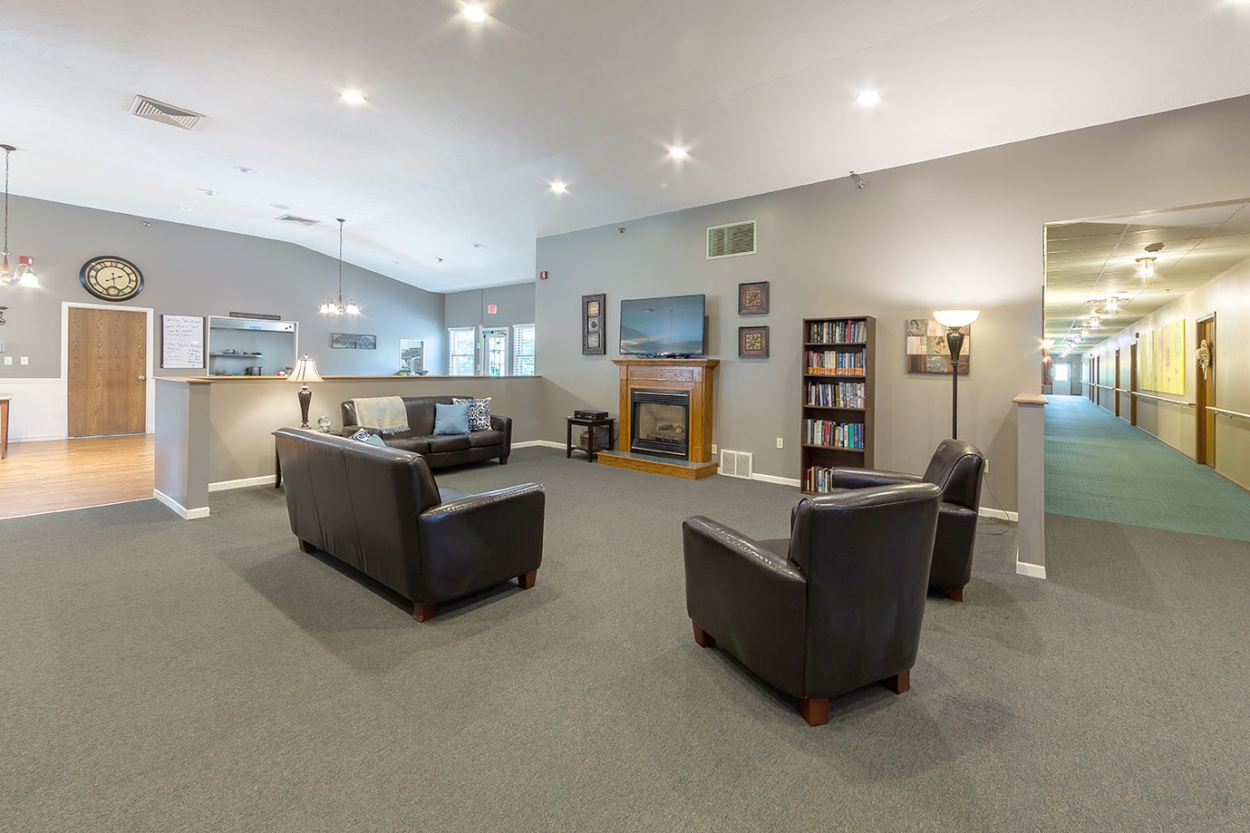Common living room with fireplace and seating